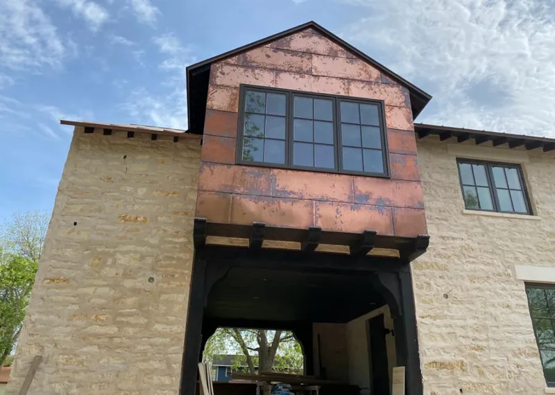 Copper metal panel facade on a stone building for Roof Repair in Solvang